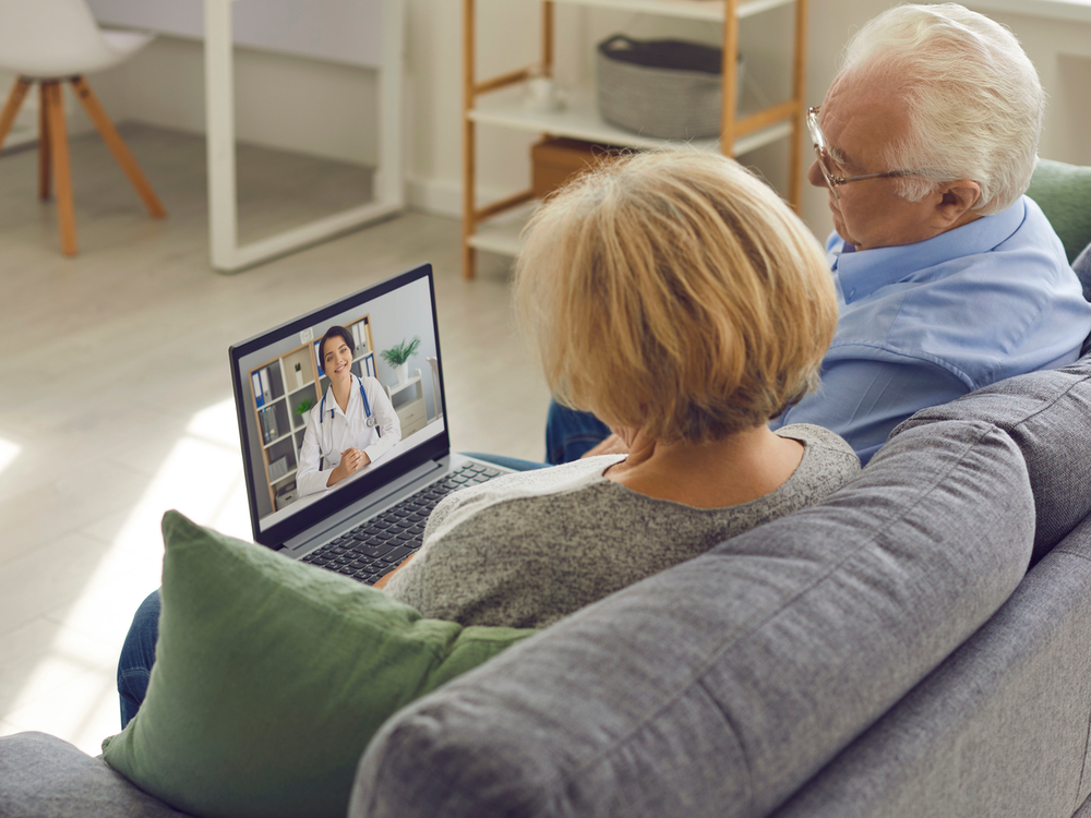 Audiologist conducting a telehealth audiology appointment remotely for a patient at Physicians Hearing Clinic in Sarasota, FL